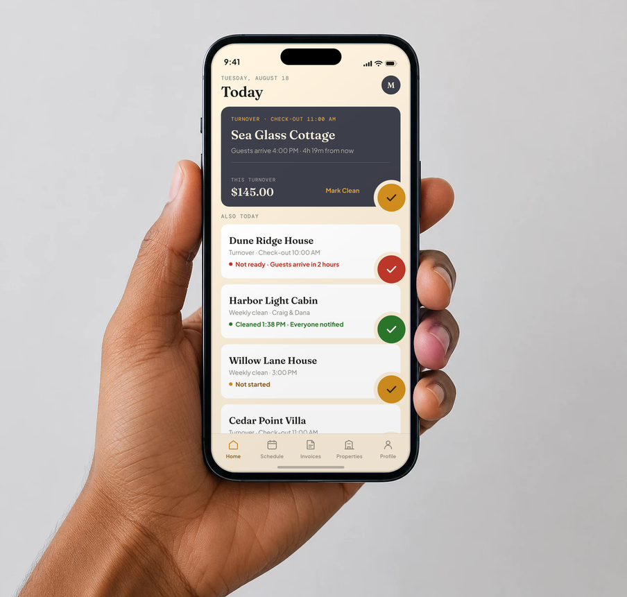 A cleaner holding a phone showing today's turnovers in CleanSlate